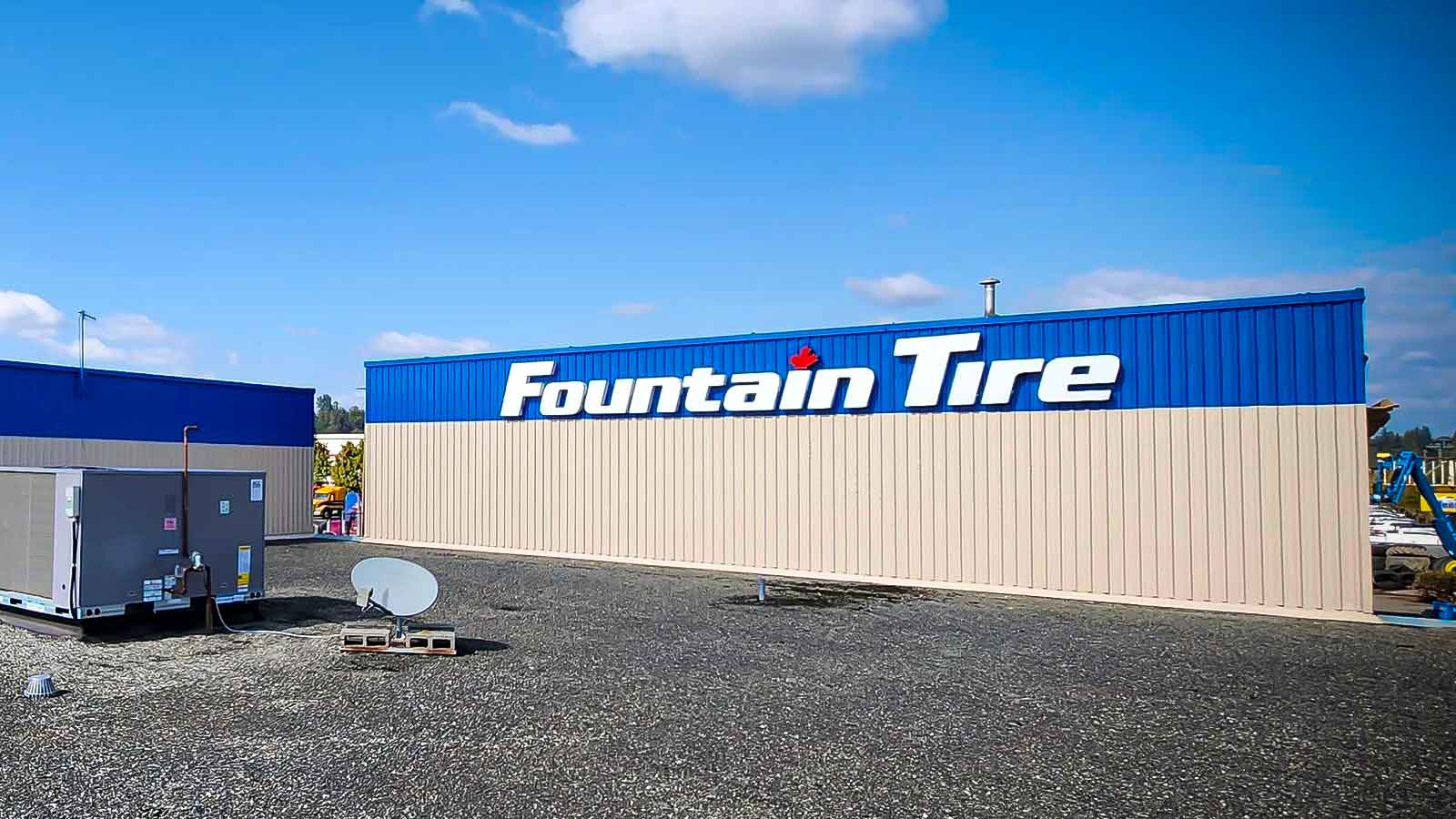 Fountain Tire sign on the side of their business on a sunny day.