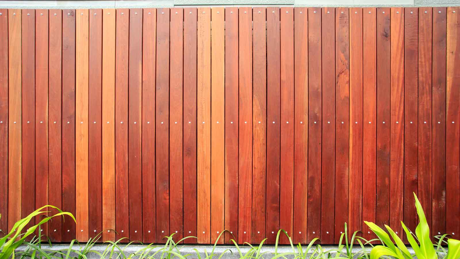 Stained Fence on a green lawn.