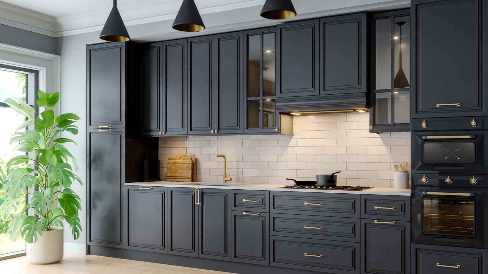 Custom black kitchen cabinets with a white backsplash and gold trimmings.