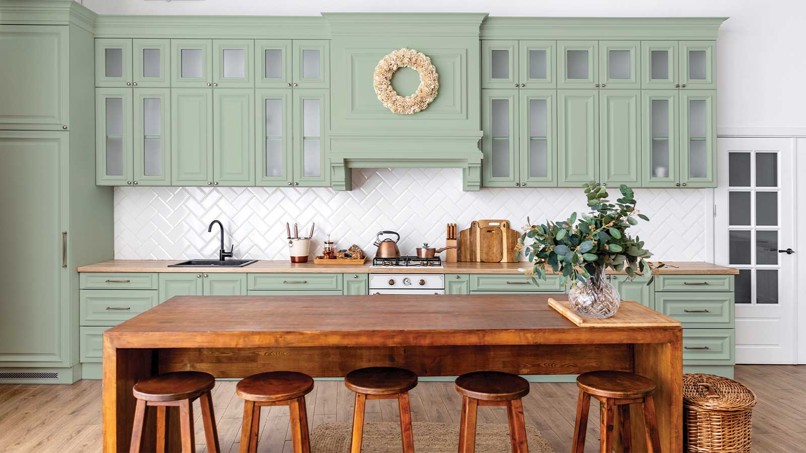 a kitchen with a table and stools