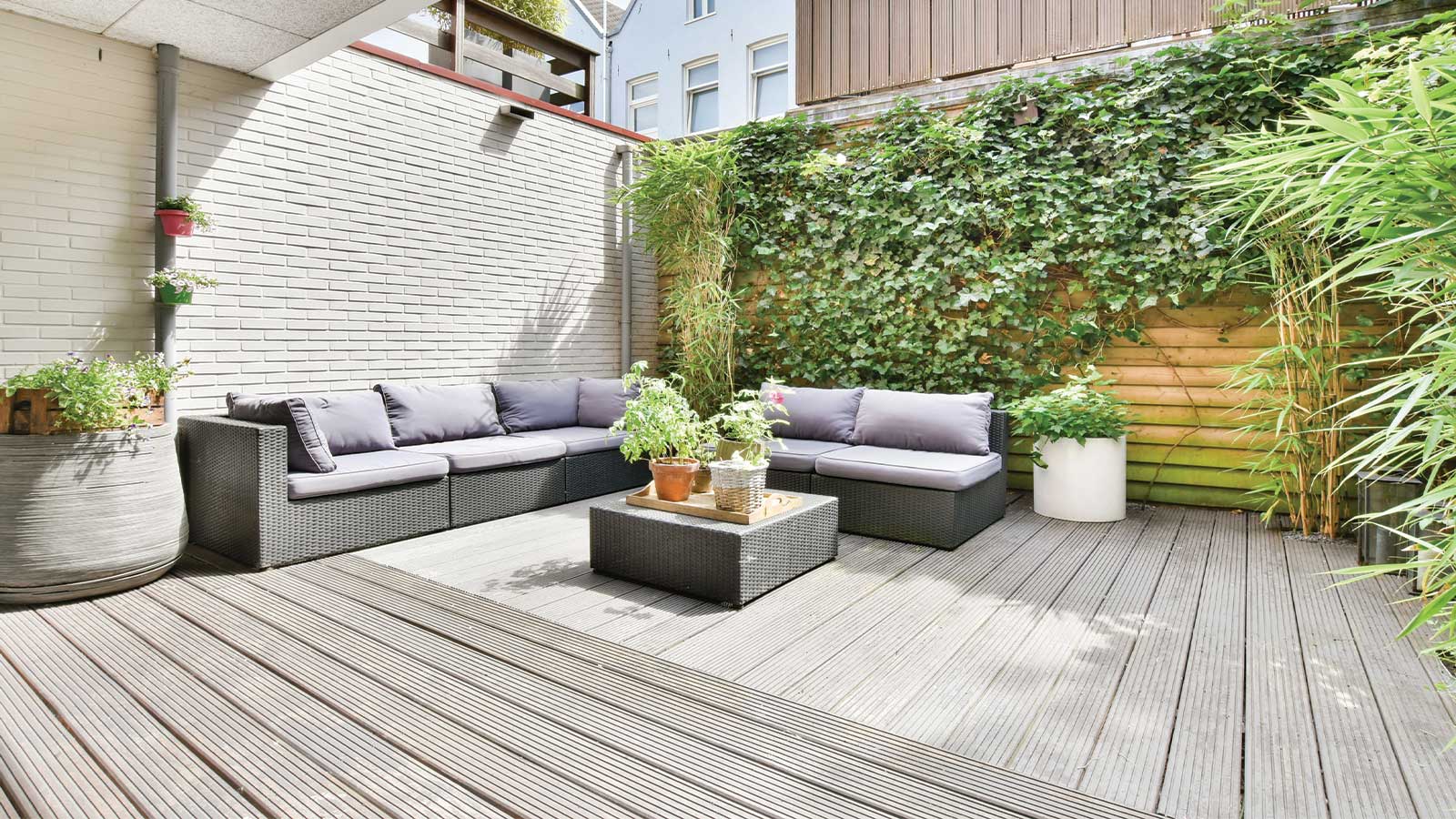 Transform your outdoor space with a modern backyard lounge featuring neutral-toned furniture, a beautifully stained wooden deck, and lush green plants, offering the perfect setting to showcase backyard paint and stain ideas. Designed for relaxation and style, this serene space highlights how the right combination of colors and finishes can enhance any outdoor area. With expert services from Roarty Painting, a trusted Maple Ridge painter, you can bring these ideas to life, ensuring your backyard is both stunning and durable year-round.