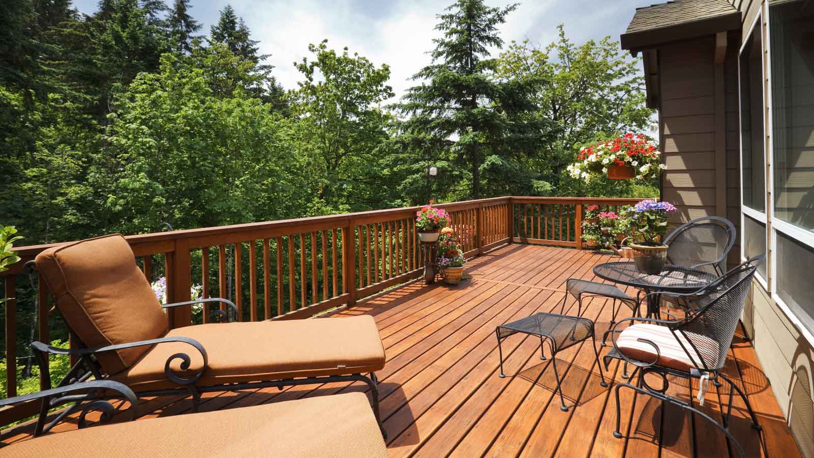 Deck with chairs and furniture out on a summer day.