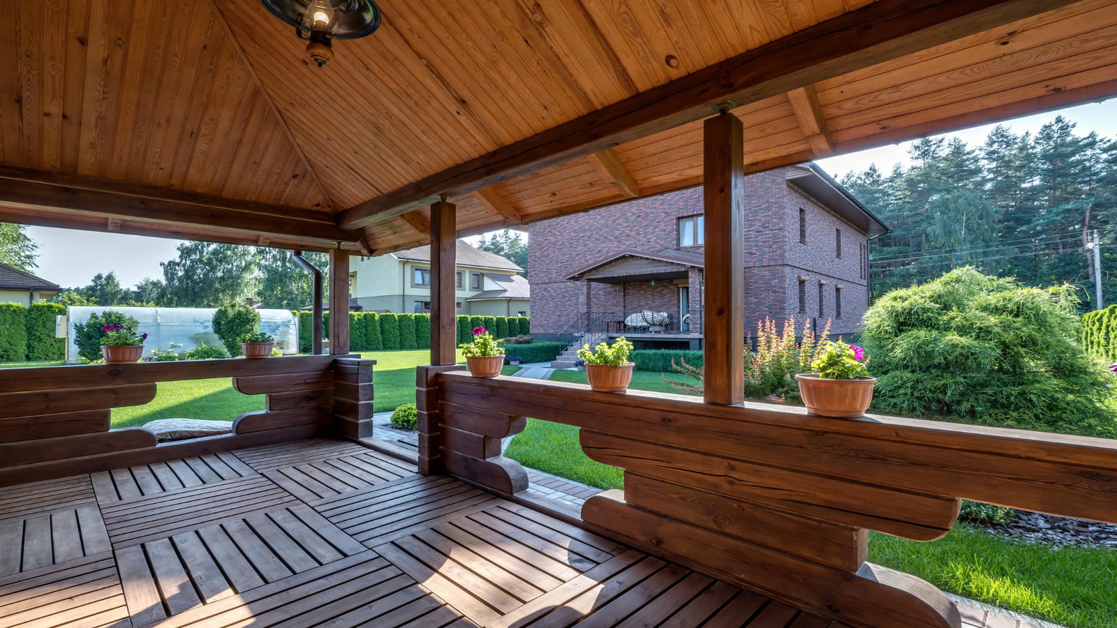 Roarty Painting highlights cozy wood patios as one of the 5 Ways to Beautify Your Backyard with Paint, adding charm to lush, landscaped spaces.