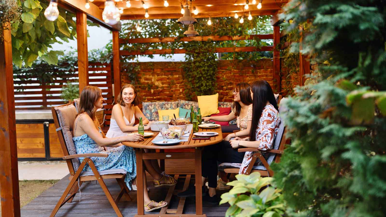 Lovely people sitting in the backyard and having some food