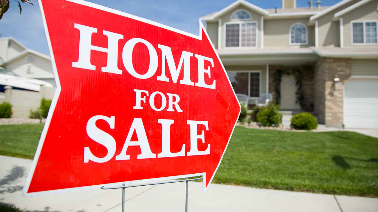 Freshen Up Your Home For Sale Red “Home for Sale” arrow sign on a front lawn with a two-story suburban house in the background.